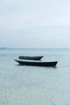Pair of empty boats floating next to each other, Zanzibar, Tanzania Foto stock