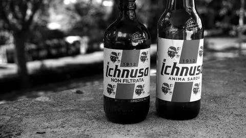 Pair of empty Ichnusa bottles on a low wall. famous Sardinian beer Stock Photos