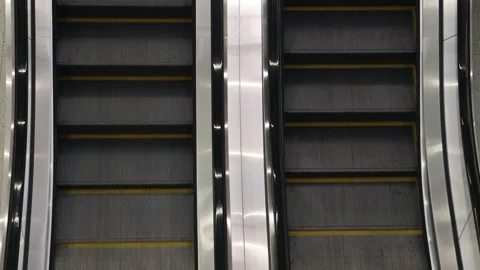 Pair of empty moving metal escalators with yellow safety lines Stock Footage 342168828