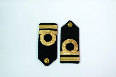 A pair of epaulette gold bar second officers, isolated on white opposite to.. Stock Photos