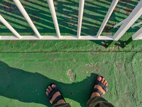 A pair of feet on the deck of a ferry Stock Photos