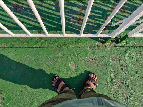 A pair of feet on the deck of a ferry Stock Photos