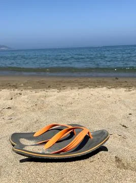 Pair of flip-flops on the beach Stock Photos