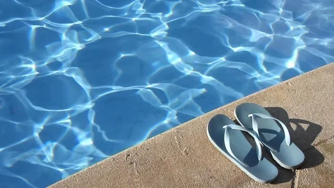 Pair of flip flops by the poolside Stock-Footage 102386468