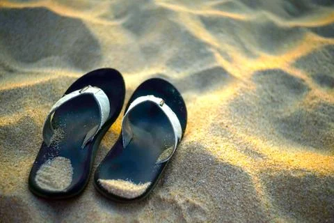 Pair of  flip flops in the sand Stock Photos