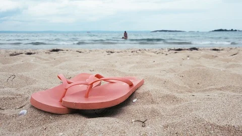 A pair of flip flops on a sandy beach. Stock Footage 114305170