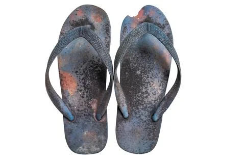 A pair of flip-flops, tattered, old and moldy isolated on a white background. Stock-Fotos