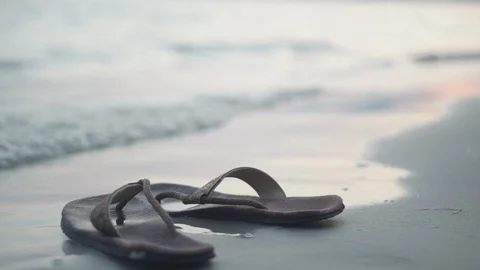 Pair of flipflops on sand Stock Footage 126231963