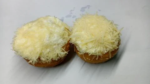 Pair of Fresh Donuts with Thick Grated Cheese Topping Foto stock
