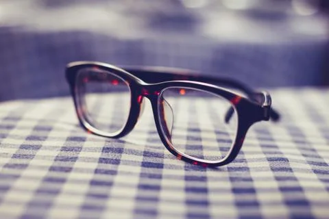 Pair of glasses on a checkered table cloth 스톡 사진