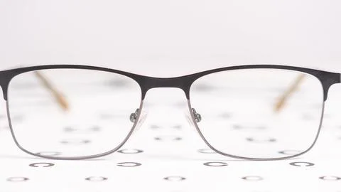 A pair of glasses is on a table with a white background Stock Photos