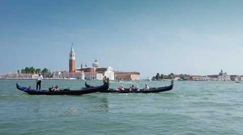 Pair gondolas rowed by a gondoliers through the San Marco Canal in Venice, Italy Stock Footage 65103011