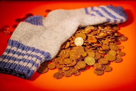 A pair of gray-blue striped wool socks sit on a large pile. Stock Photos