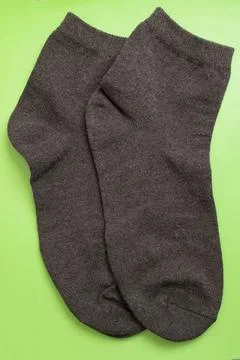 Pair of gray socks on green background Stock Photos