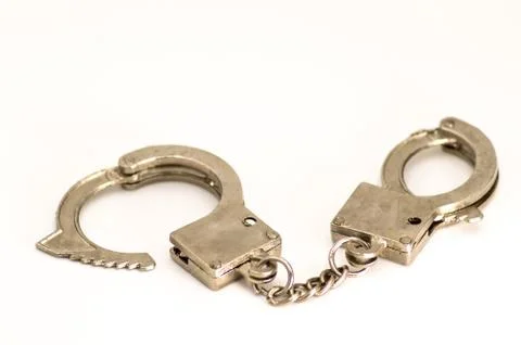 Pair of handcuffs close up front view Stock Photos