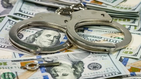 Pair of handcuffs closeup on dollar banknotes background. Corruption problem Stock-Footage 78887199
