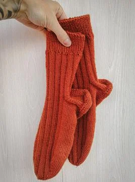 A pair of handmade knitted wool socks Stock Photos