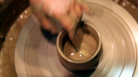 Pair of hands forms clay pot on potter's wheel Video stock 693236