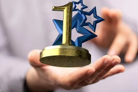 Pair of hands holding a 3D render of a first place trophy 스톡 사진