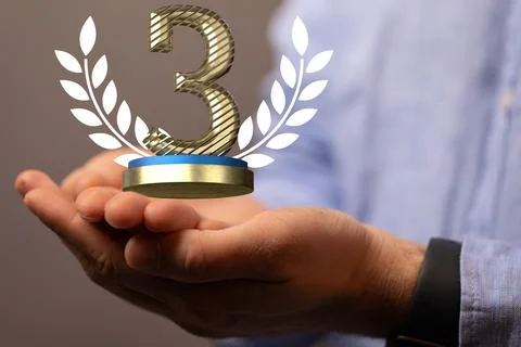 Pair of hands holding a 3D render of a third place trophy 스톡 사진