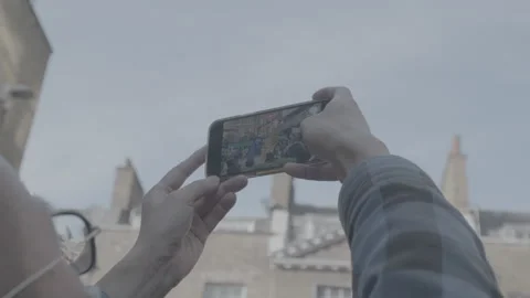 A pair of hands holding a mobile phone taking a video Stock Footage 219316397