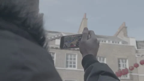 A pair of hands holding a mobile phone taking a video Stock Footage 219316408