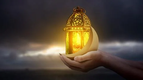 A pair of hands holding a traditional Arabic lantern and crescent moon, sym.. Ilustração Stock