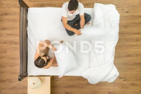 The pair have a fun on the bed. View from above Stock Photos