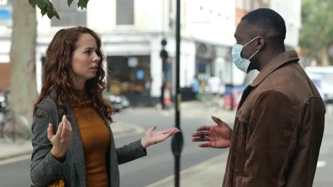 Pair having argument about wearing masks on pavement Video stock 141384968