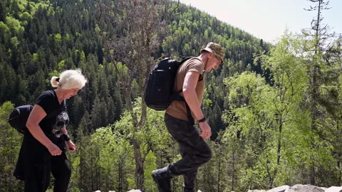 A pair of hikers walk in front of the camera. Video stock 311251941