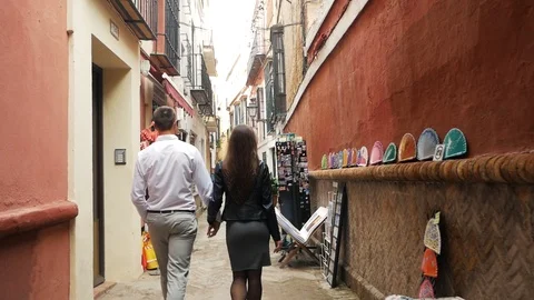 Pair holding hands and walking Stock Footage 87687117