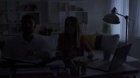 Pair of home office workers experiencing a power outage. Stock Footage 219688883