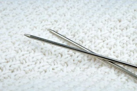 Pair of knitting needles isolated over white. Sweater or scarf White Croche.. Stock Photos