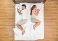 The pair lay on the bed and phone. View from above Photo