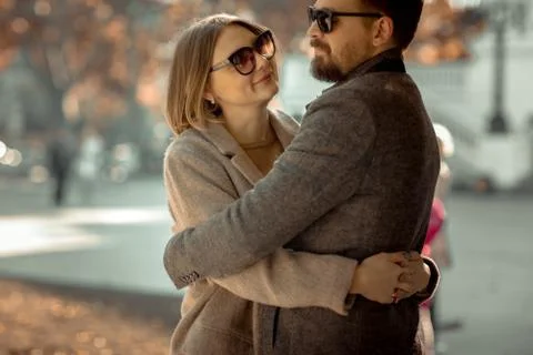 The pair of lovers cuddle and hold hands during a romantic outing Stock Photos