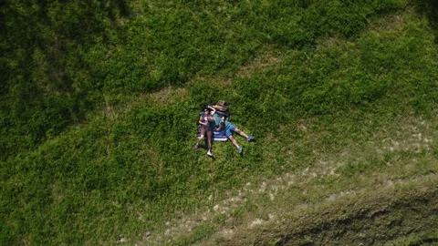 Pair of lovers lying on the grass chatting tenderly Stock-Footage 158458471