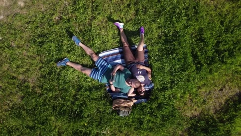 Pair of lovers lying on the grass chatting tenderly Video stock 158458481