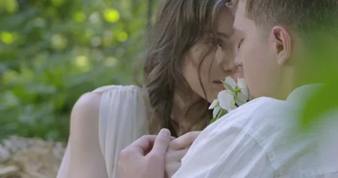 A pair of lovers sit in the spring garden Stock Footage 246406819