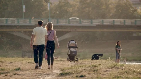A pair of lovers stroll along the river. People are resting. Transport bridge in 스톡 동영상 94247430