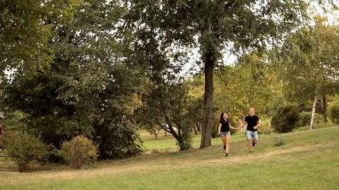 Pair of lovers strolling in the Park holiday Stock Footage