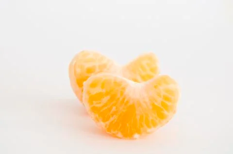Pair of mandarin orange segments on white background Stock Photos