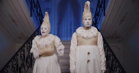 Pair of mimes in beautiful old white theatrical costumes make grimaces faces and Stock Footage 132433013