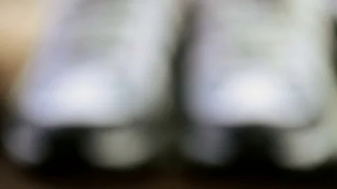 Pair of new womens hiking shoes with topo map on a wood background. Stock Footage