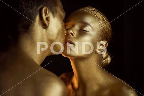 Pair, painted with gold paint, kisses. Affinity, unreality, single unit Stock Photos