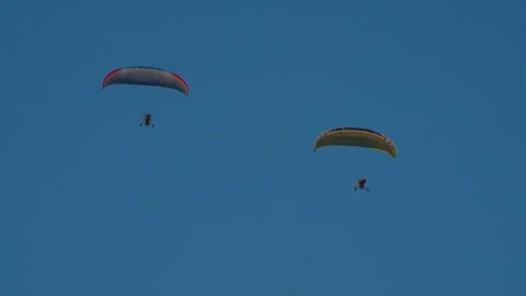 Pair of paragliders are flying in tandem Stock Footage 329552183