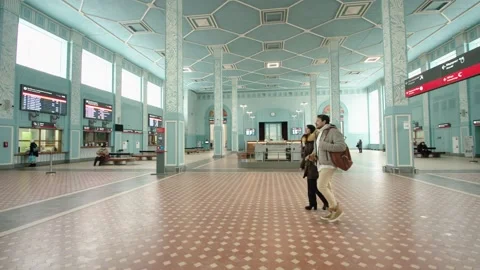Pair of passengers are talking to each other inside building of airport or Stock Footage 199516598