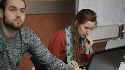 Pair of people works in office on laptops sitting at wooden table Stock Footage 66517853