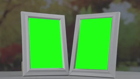 Pair of photo frames with green chroma key space placed at home table in autumn Stock Footage 260698167