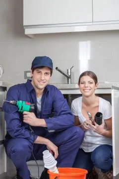 Pair of plumbers working happily Stock Photos