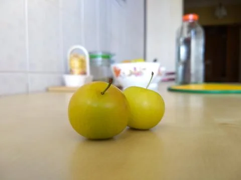 A pair of plums on the table, close-up green plums Stock Photos
